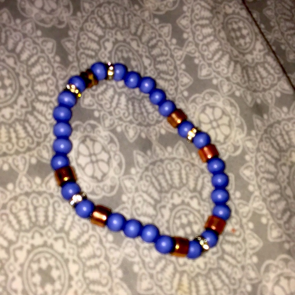 A blue bracelet with rose gold decal and diamond links